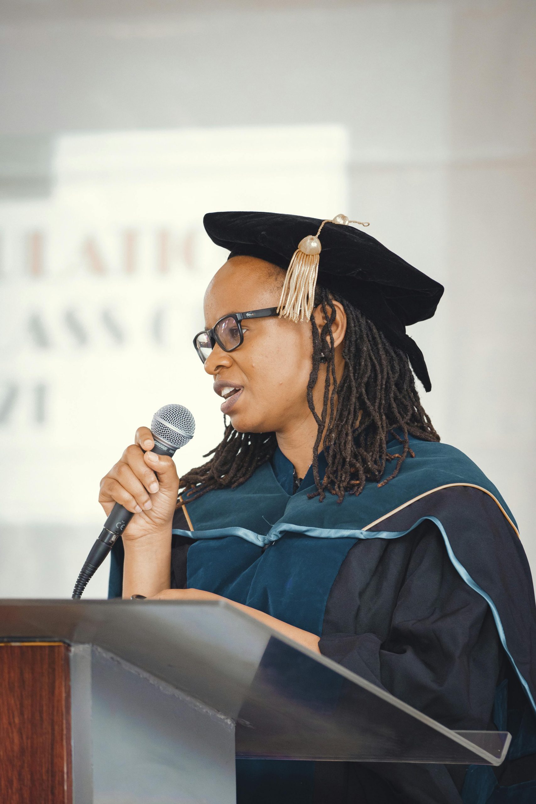 Woman speaking at a graduation ceremony in Nairobi, Kenya.